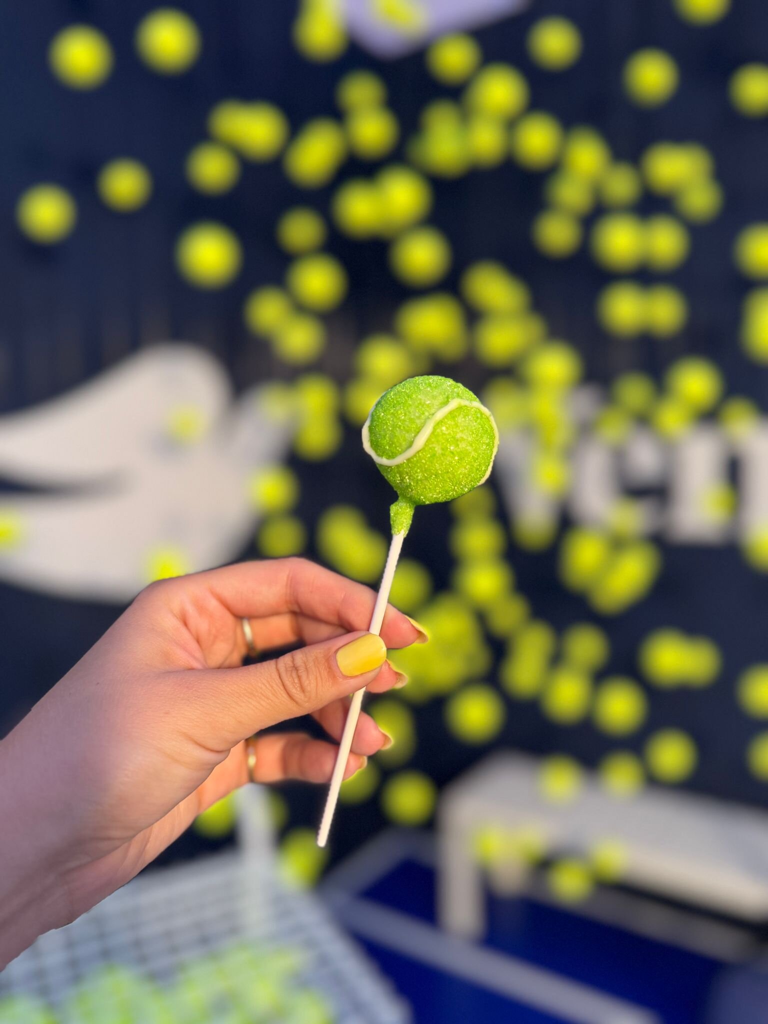 Custom tennis ball cake pop created for a brand activation