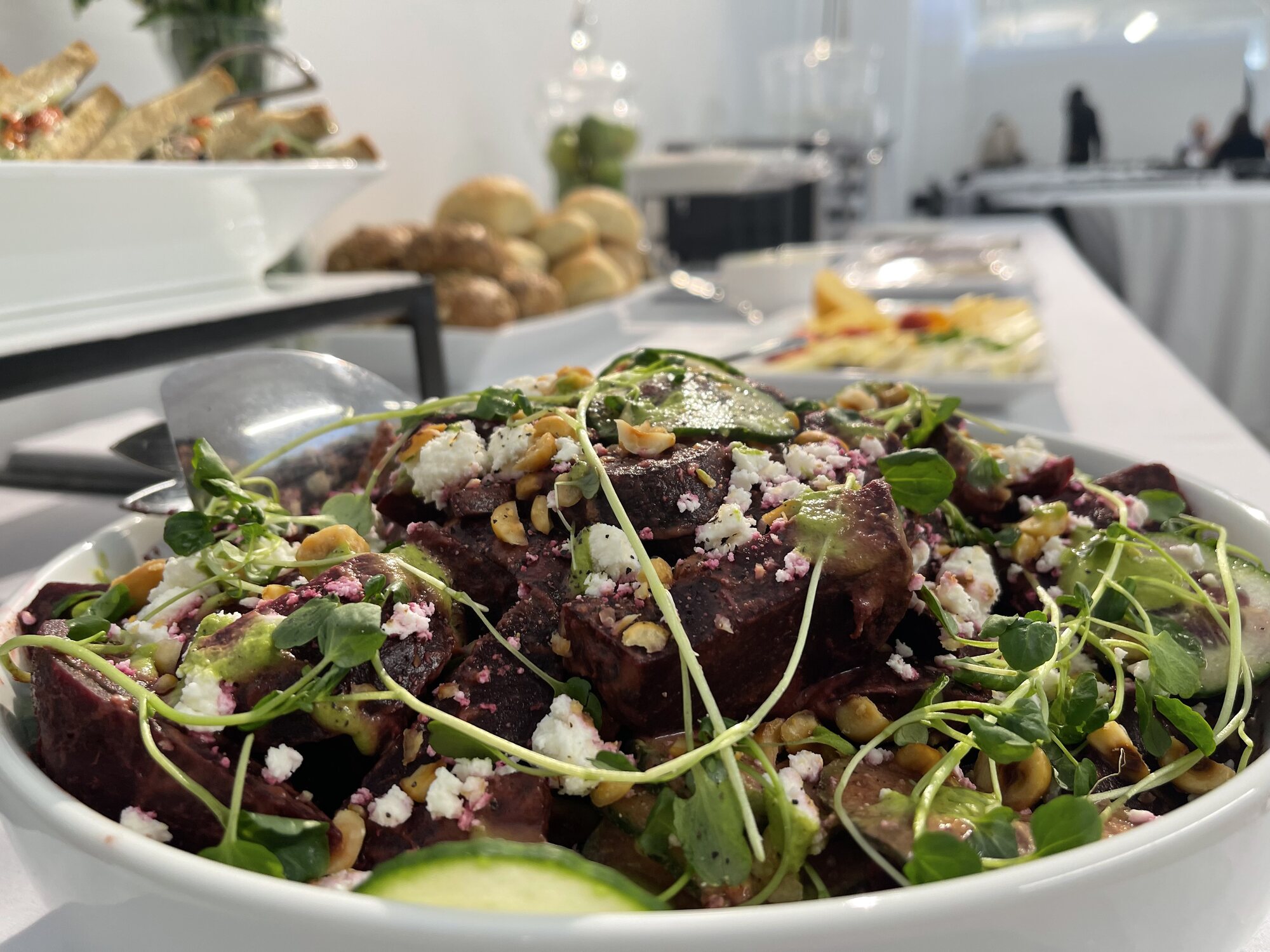 Office lunch buffet with roasted beet salad and fresh rolls