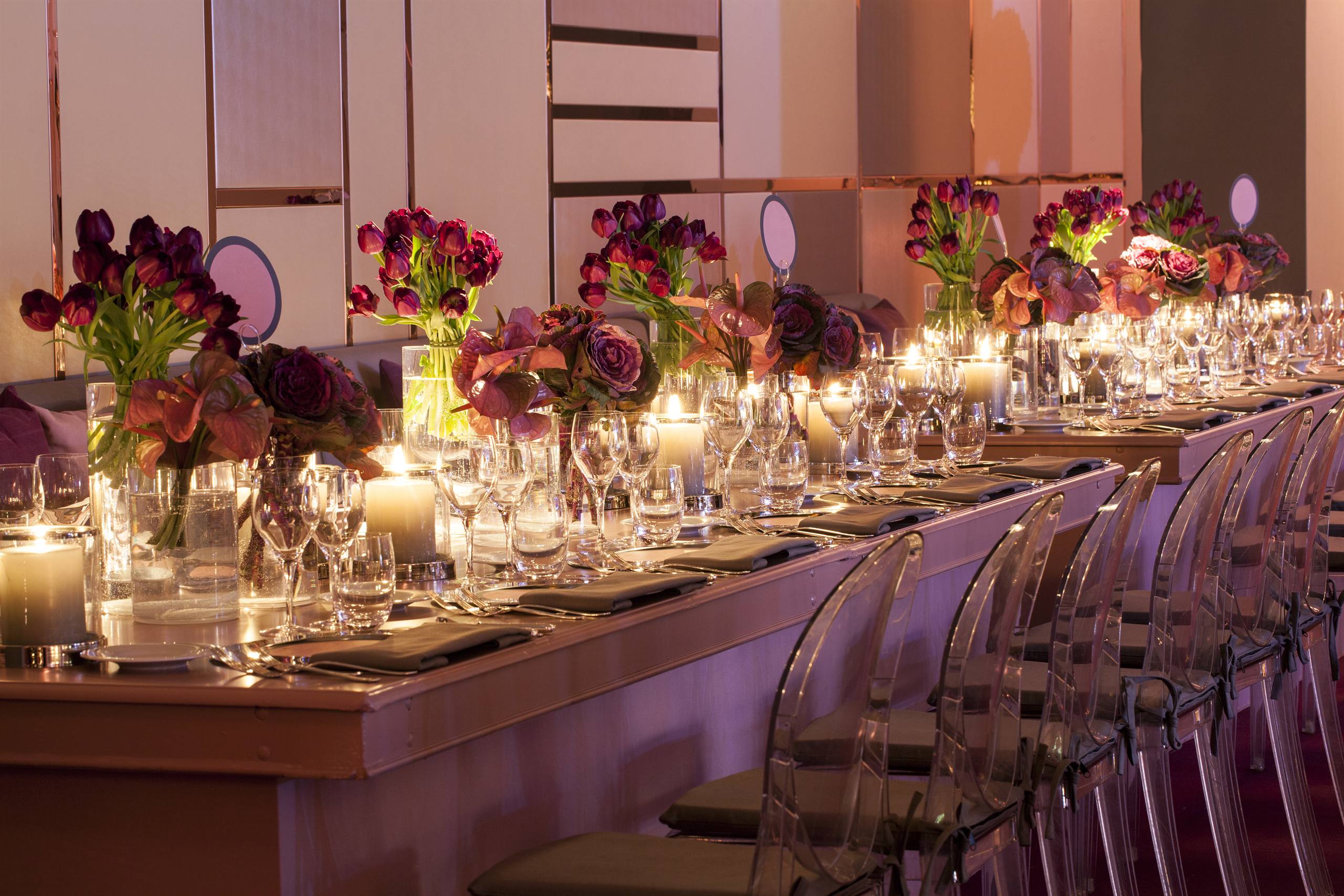 Candlelit gala dinner tables with lush floral centerpieces