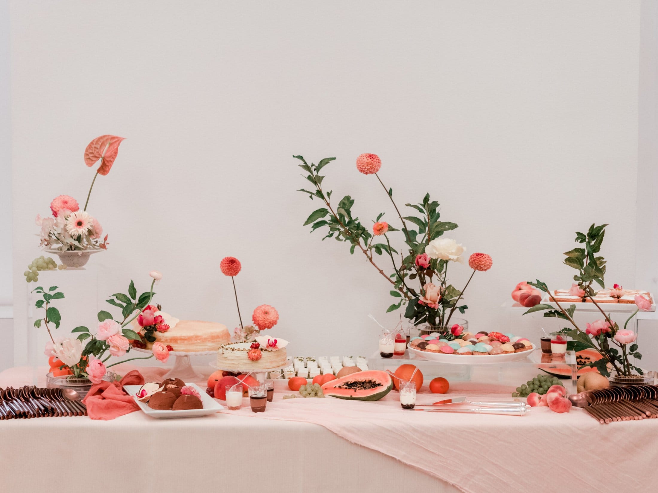 Styled dessert table with pink florals and sweets